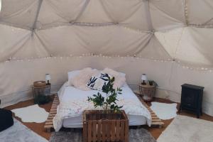 a bedroom with a bed in a tent at Pewsey Countryside Dome - Dog Friendly - Fire pit in Pewsey