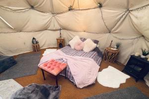 a room with a bed in a tent at Pewsey Countryside Dome - Dog Friendly - Fire pit in Pewsey