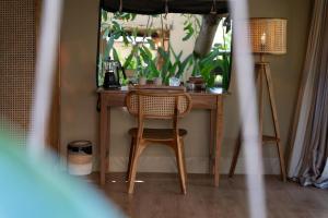 a table and chair in a room with a mirror at Vela Tianyar Boutique Resort - Oceanfront in Tianyar +46 photos