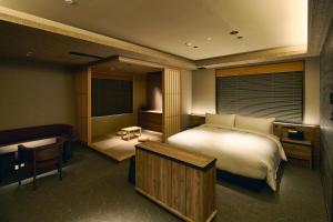a bedroom with a large bed and a window at Gion Kuromatsu in Kyoto