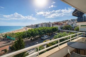 a balcony with a view of a beach and the ocean at La Casa de la Punta in San Pol de Mar