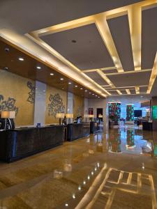 a lobby of a hotel with a reception desk at China National Convention Center Grand Hotel in Beijing