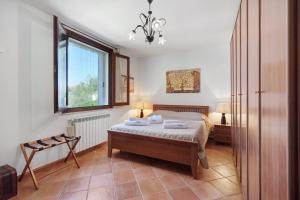 a bedroom with a bed and a window at Villa Dalia con piscina in Partinico +25 photos