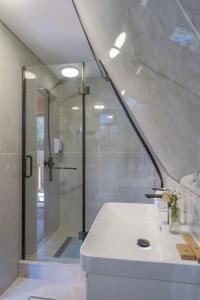 a bathroom with a shower and a white sink at Tengri Village Karakol in Karakol +136 photos