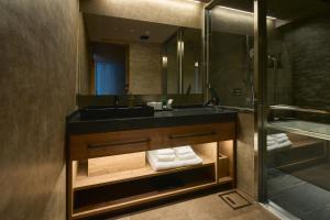a bathroom with a sink and a mirror at Gion Kuromatsu in Kyoto +44 photos