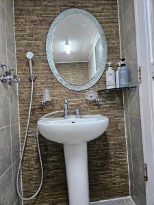a bathroom with a sink and a mirror at Tohyang Traditional House in Bonghwa