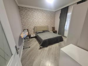 a bedroom with a bed and a table and a window at dlb VILLA 2 in Baku +11 photos
