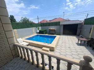 a swimming pool with two chairs on a balcony at dlb VILLA 2 in Baku