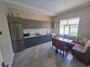 a kitchen and living room with a couch and a table at dlb VILLA 2 in Baku