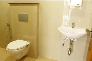 a bathroom with a toilet and a sink at SR Castle Gopalapuram in Chennai