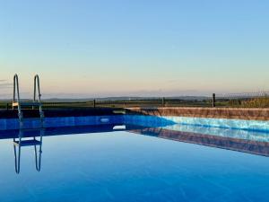 a swimming pool with a reflection in the water at Apartamenty Piotrowice in Piotrowice