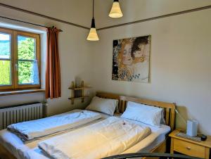 a bedroom with two beds and a window at Ferienwohnung Rösslstube in Ruhpolding