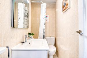 a small bathroom with a sink and a toilet at The Triplets in Agres +17 photos