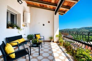 a patio with furniture and a view of a vineyard at The Triplets in Agres