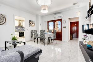 a dining room and living room with a table and chairs at The Triplets in Agres