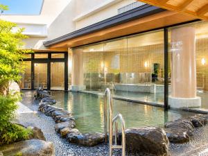 a swimming pool in front of a building at City Plaza Osaka in Osaka