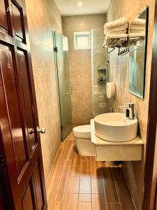 a bathroom with a sink and a toilet at New Conson Hotel in Con Dao