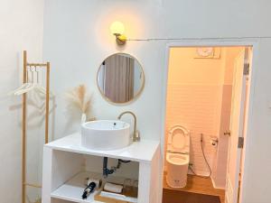 a bathroom with a sink and a mirror at Seoul House นครสวรรค์ in Sathani Pak Nam Pho