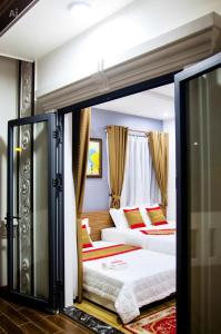a room with two beds and a window at New Conson Hotel in Con Dao