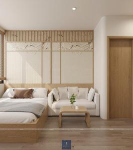 a bedroom with a bed and a couch and a table at Urban Nest in Hanoi