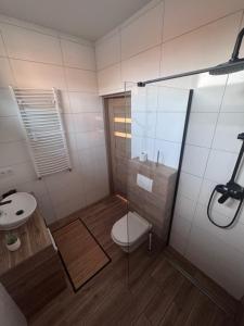 a bathroom with a shower with a toilet and a sink at Hostel Suchedniów in Suchedniów