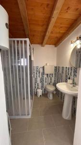 a bathroom with a sink and a toilet at Il Villaggetto sul Mare in Favignana
