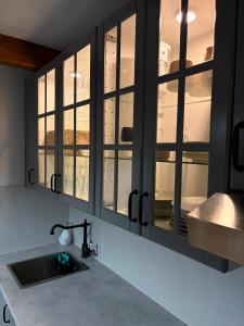 a kitchen with a sink and some windows at Chalet Le Klet in Krapinske Toplice