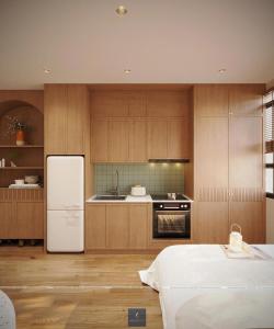 a kitchen with wooden cabinets and a white refrigerator at Urban Nest in Hanoi