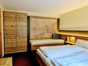 a bedroom with two beds and a painting on the wall at Ferienwohnung Jodlschmid in Ruhpolding