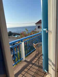 a balcony with a view of the ocean at Faros Rooms Armenistis in Armenistis