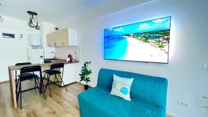 a living room with a blue couch and a table at Saturn ROOMS in Saturn