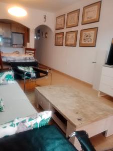 a living room with a table and a couch at Sol y playa in Palomares