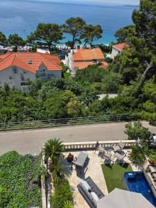 an aerial view of a house and the ocean at Apartment relax jacuzzi terrace with sea view in Brela