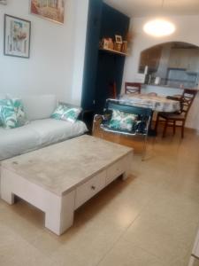 a living room with a couch and a table at Sol y playa in Palomares