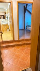 a view of a bathroom with a mirror and a room at Apartmány v Žitě in Třeboň +28 photos