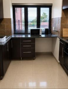 a kitchen with a counter with a laptop on it at Staynrestapartment in Nelspruit