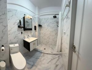 a bathroom with a white toilet and a sink at Saturn ROOMS in Saturn +137 photos
