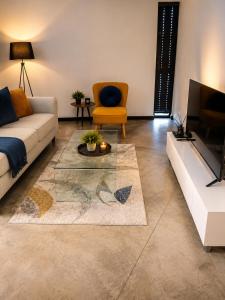 a living room with a couch and a tv at Staynrestapartment in Nelspruit +1 photo
