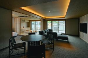 a living room with a couch and a table and chairs at Gion Kuromatsu in Kyoto