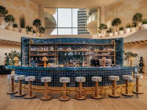 a bar in a hotel lobby with stools at Les Cimes Bleues in La Baule