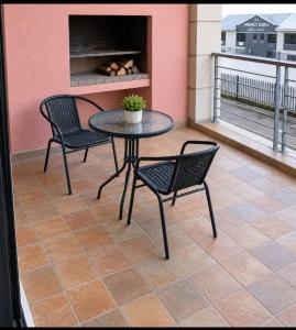 a patio with a table and chairs on a balcony at Staynrestapartment in Nelspruit