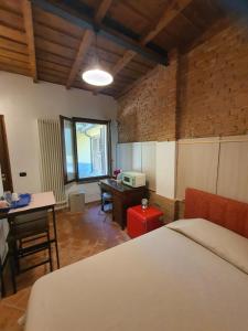 a bedroom with a bed and a desk and a table at Collina del Milanese in San Colombano al Lambro