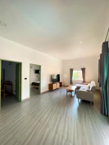 a living room with a couch and a table at Hornbill Pool Villas 1 in Ko Chang