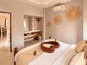 a bedroom with a bed with a dog laying on it at Casa Eden - Double King Bed - Peaceful Garden Retreat - 4K SmartTV in Thong Sala