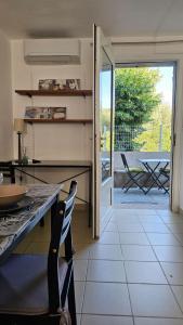 a kitchen with a table and a view of a patio at Studios Corte Restonica in Corte