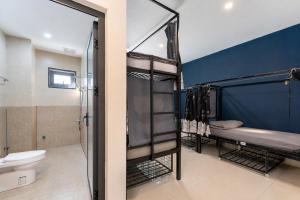 a bathroom with two bunk beds and a toilet at Two Horses Hostel in Hoi An +52 photos