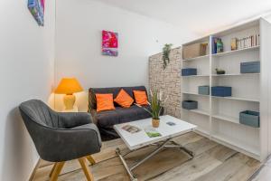 a living room with a couch and a table at Studio piscine Alpilles in Noves
