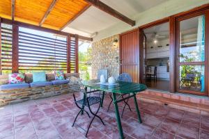 a patio with a table and chairs on a porch at Casa 2 Punta Negra Vista Mare in Stintino +19 photos