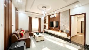 a living room with a couch and a tv at New Conson Hotel in Con Dao