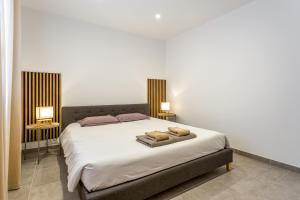 a bedroom with a bed with two towels on it at Villa Hestia in Goudargues +19 photos